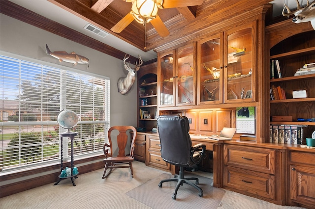 office area featuring light carpet, coffered ceiling, visible vents, built in features, and crown molding