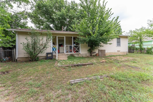 view of front of home with a front yard, a porch, and fence
