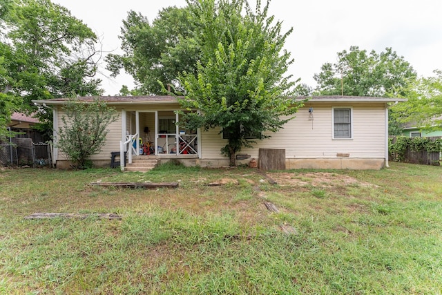 back of house with a yard, covered porch, and fence