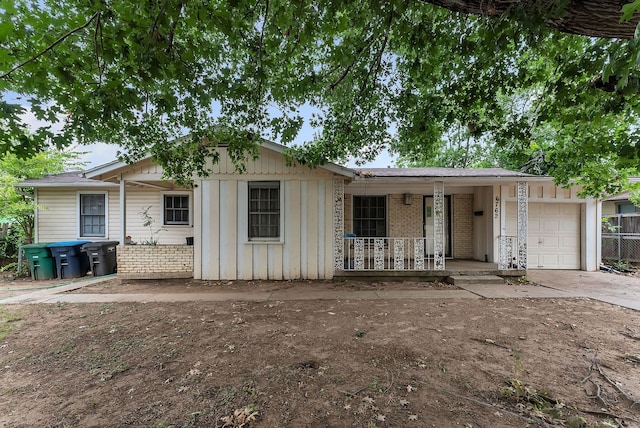 ranch-style house featuring a garage and covered porch