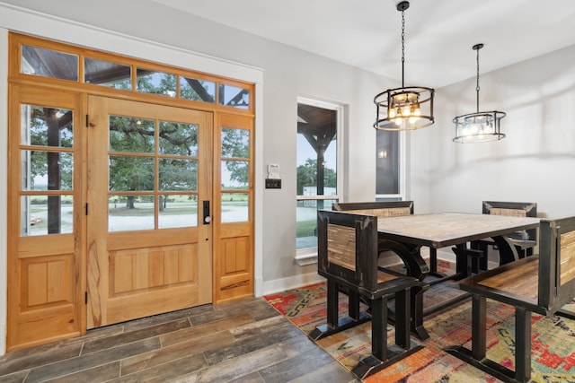 dining area featuring an inviting chandelier and dark wood-type flooring