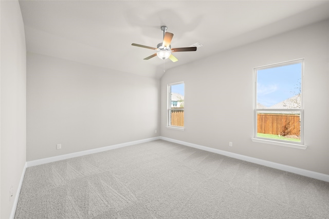 carpeted empty room with vaulted ceiling and ceiling fan