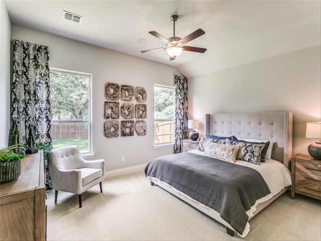 bedroom with lofted ceiling, ceiling fan, and light colored carpet