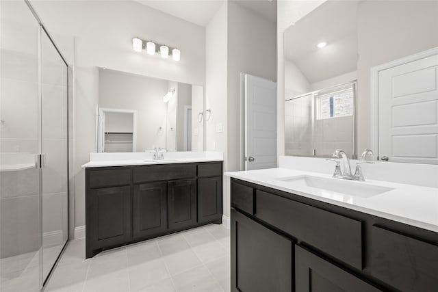 bathroom with vanity, lofted ceiling, an enclosed shower, and tile patterned floors