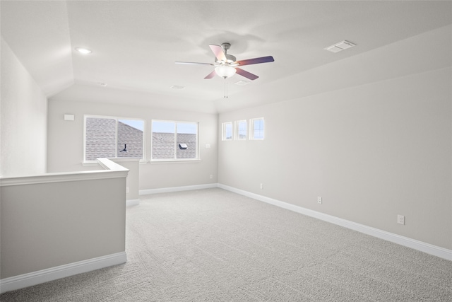 unfurnished room featuring vaulted ceiling, ceiling fan, and light carpet