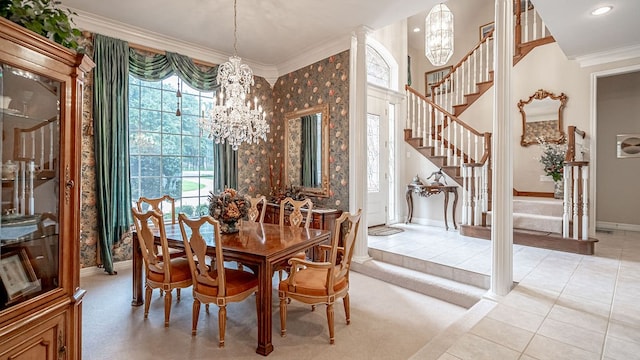 tiled dining space featuring ornamental molding, decorative columns, and an inviting chandelier