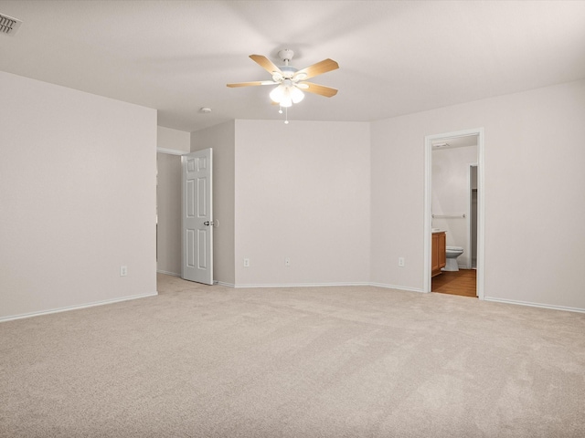 empty room featuring ceiling fan and light carpet