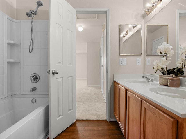 bathroom featuring vanity, hardwood / wood-style flooring, and shower / washtub combination