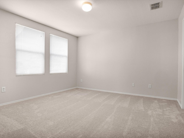 empty room featuring light colored carpet