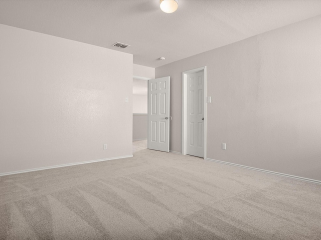 empty room with light colored carpet