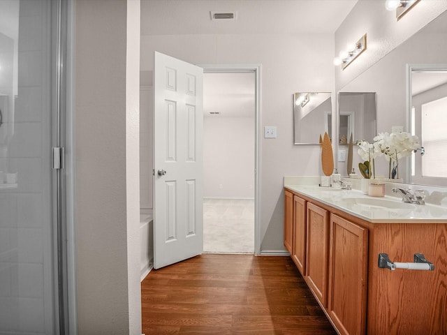 bathroom with hardwood / wood-style flooring and vanity