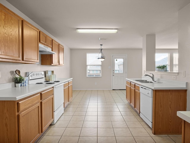 kitchen with sink, decorative light fixtures, light tile patterned floors, a wealth of natural light, and white appliances