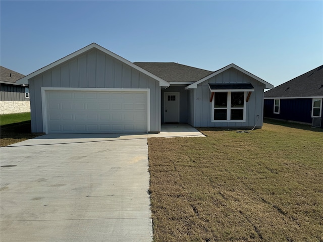 single story home with a garage and a front lawn