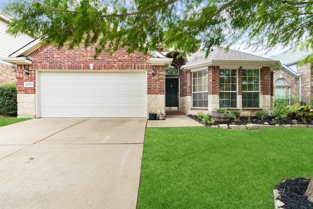 view of front of property with a garage and a front lawn