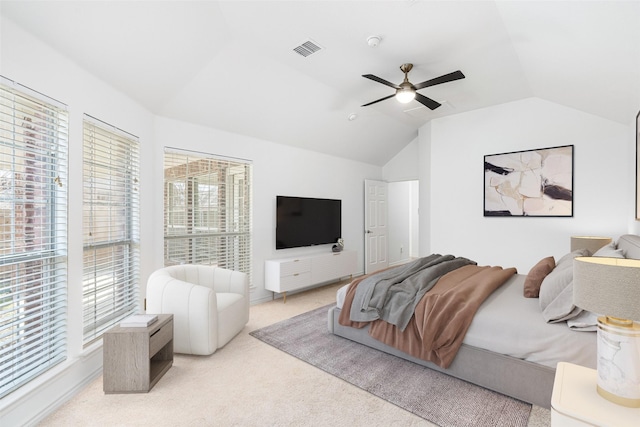 carpeted bedroom featuring ceiling fan, multiple windows, and lofted ceiling