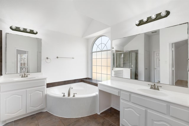 bathroom featuring shower with separate bathtub, vanity, and vaulted ceiling