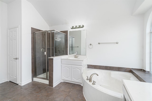 bathroom featuring separate shower and tub, vaulted ceiling, and vanity