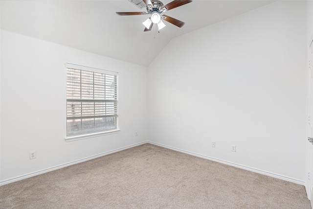 carpeted spare room featuring lofted ceiling and ceiling fan