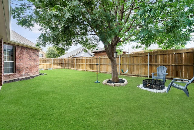 view of yard featuring an outdoor fire pit