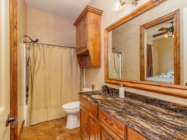 bathroom with toilet, ceiling fan, vanity, and tile patterned floors