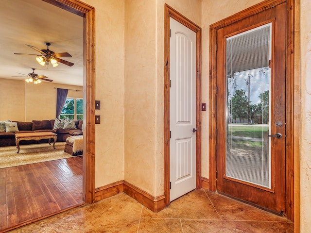 interior space with ceiling fan and light tile patterned flooring