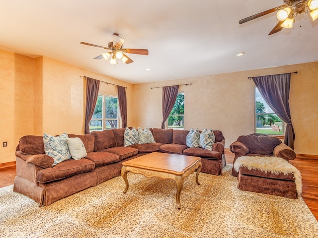 living room featuring ceiling fan, hardwood / wood-style floors, and a healthy amount of sunlight