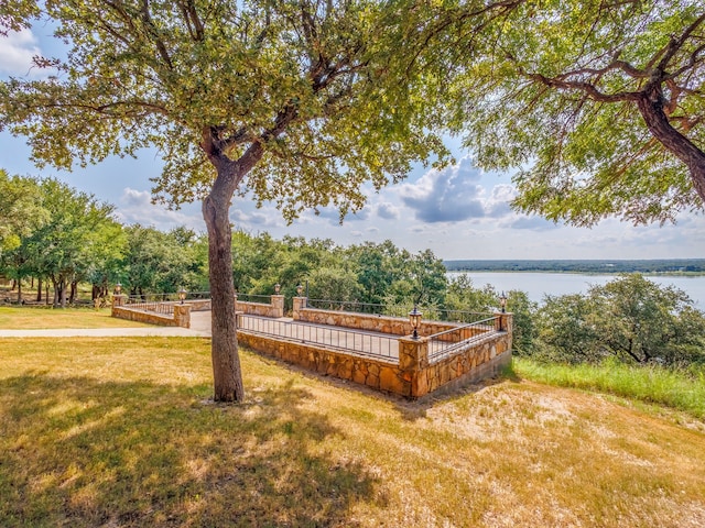 exterior space with a lawn and a water view