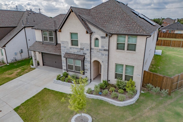 french country home with a garage and a front lawn