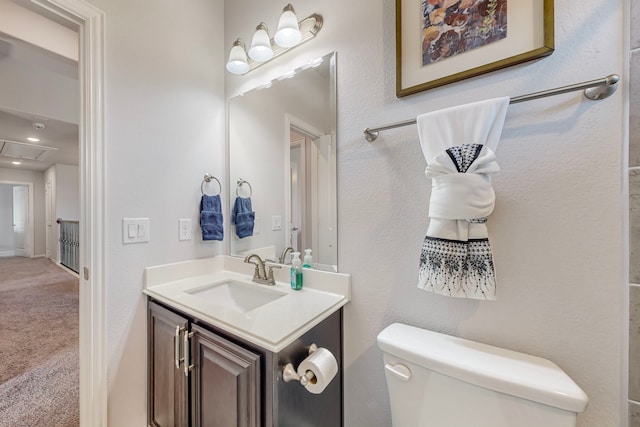 bathroom featuring toilet and vanity