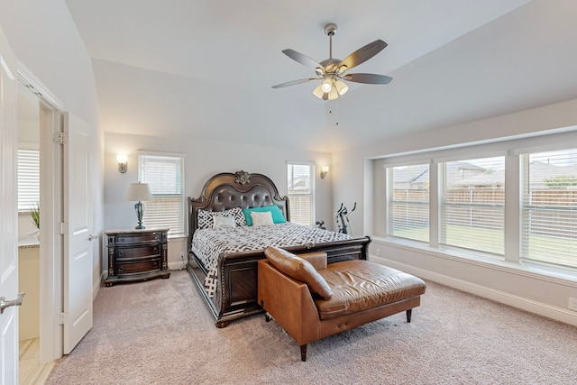 carpeted bedroom featuring vaulted ceiling, multiple windows, and ceiling fan