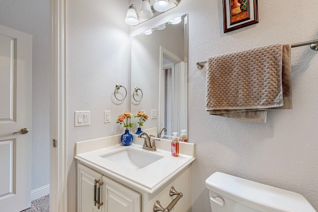 bathroom featuring toilet and vanity