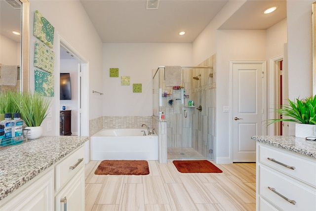 bathroom with vanity, independent shower and bath, and tile patterned floors