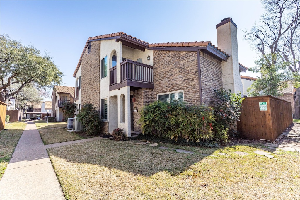 exterior space featuring central AC, a balcony, and a front lawn