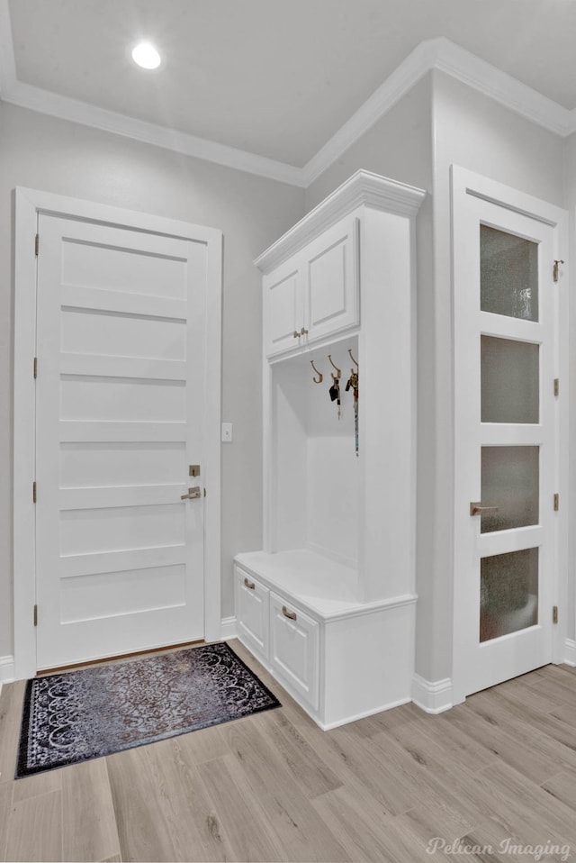 mudroom featuring light hardwood / wood-style flooring and crown molding