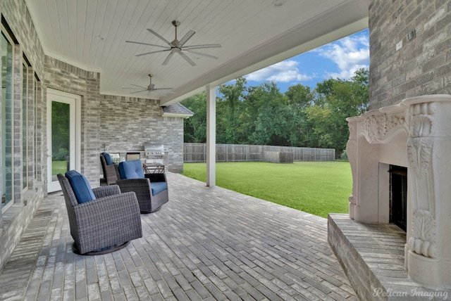 view of patio / terrace with ceiling fan, exterior fireplace, and area for grilling