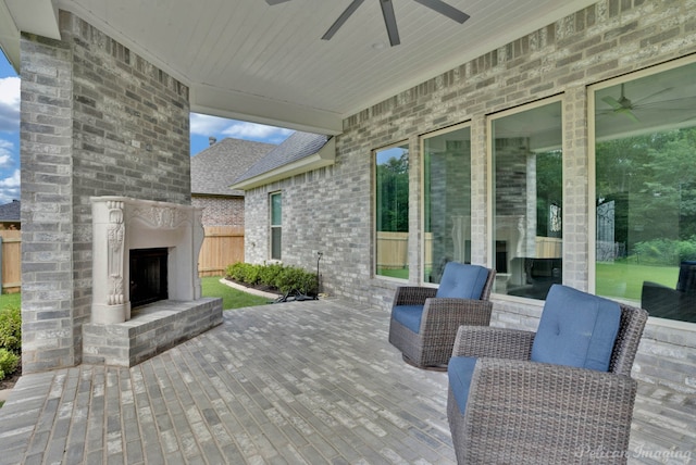 view of patio / terrace featuring ceiling fan and an outdoor brick fireplace