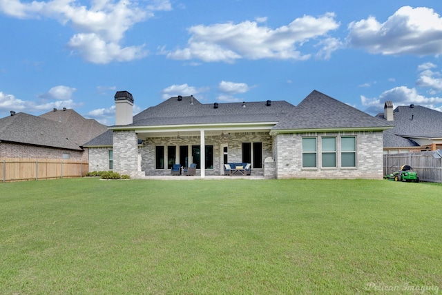 back of house featuring a patio area and a lawn