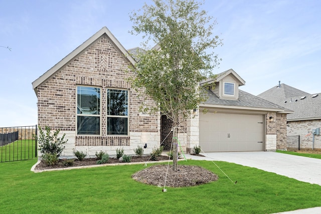 view of front of house with a front yard and a garage