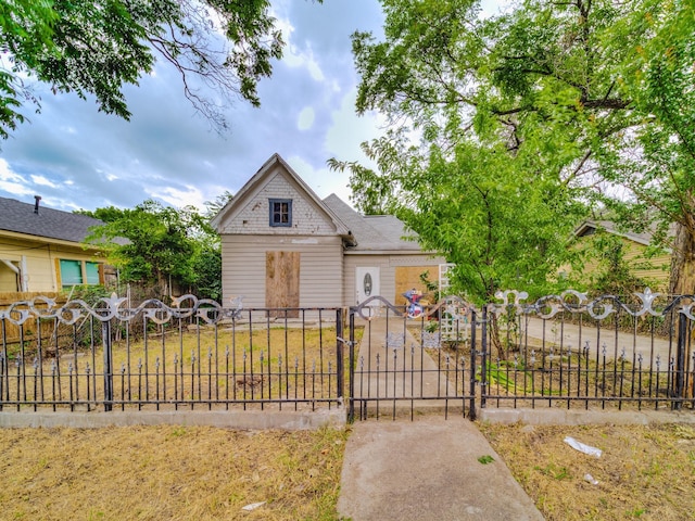 view of front of property with a fenced front yard and a gate