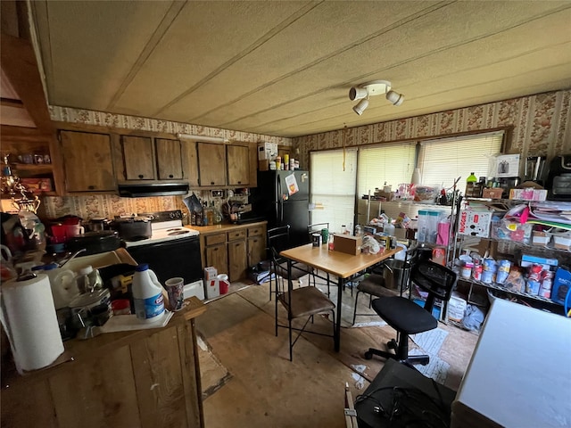 kitchen featuring black refrigerator and white electric range oven