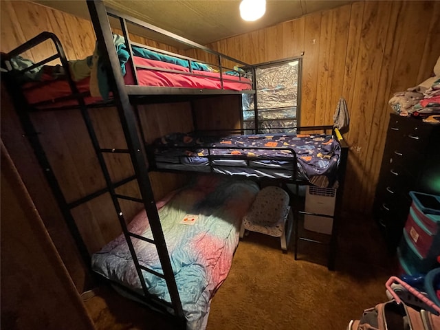 bedroom with carpet and wooden walls