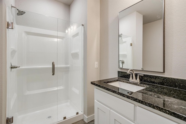 bathroom with an enclosed shower and vanity