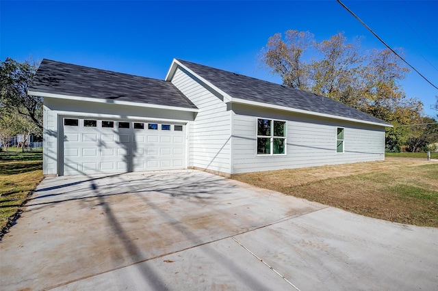 view of home's exterior featuring a garage and a yard