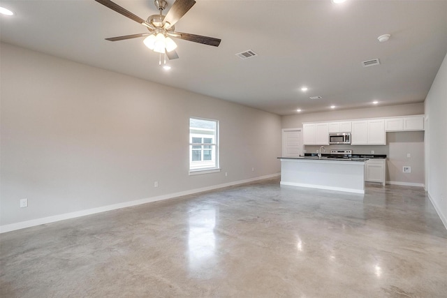 unfurnished living room with ceiling fan and sink