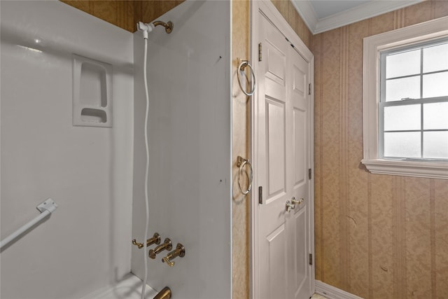 bathroom featuring crown molding, a healthy amount of sunlight, and tub / shower combination