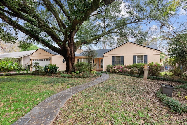 ranch-style house with a front lawn and a garage