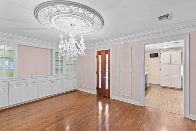 interior space with hardwood / wood-style flooring and ornamental molding