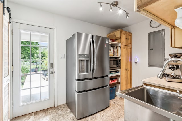 kitchen with stainless steel fridge with ice dispenser, light tile patterned flooring, rail lighting, electric panel, and sink