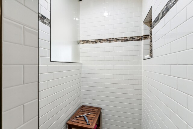 bathroom with tiled shower