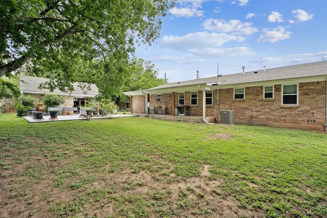 view of yard with a patio and central AC unit